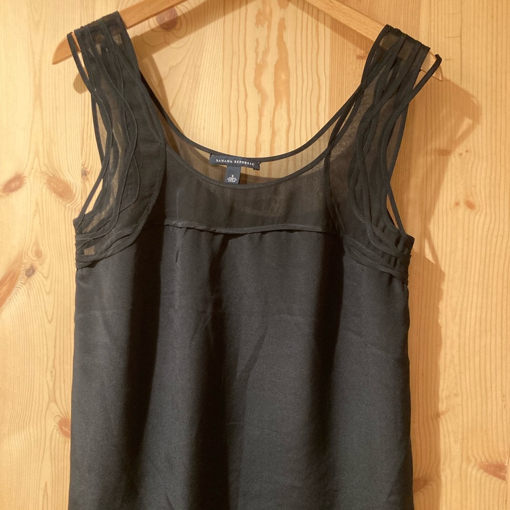Black sleeveless top with delicate neck detailing
